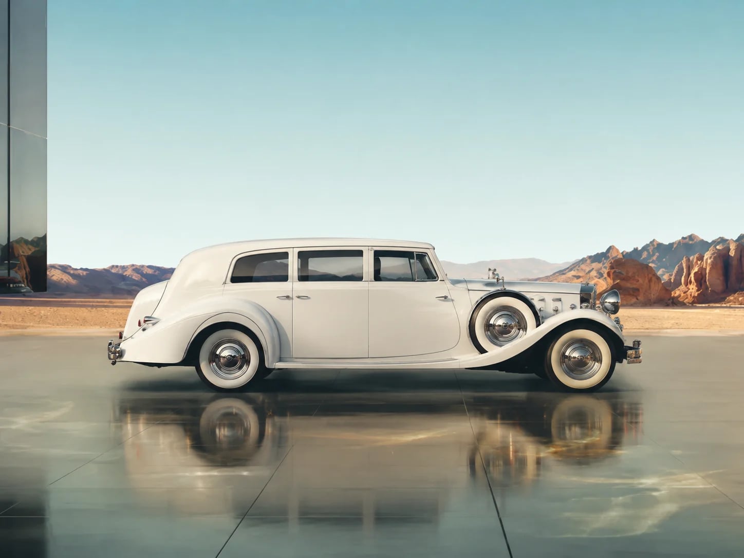A white vintage Danaro wedding car facing right in a cinematic landscape.