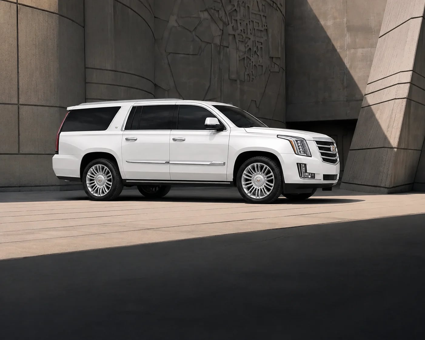 A white Cadillac Escalade luxury SUV facing right.