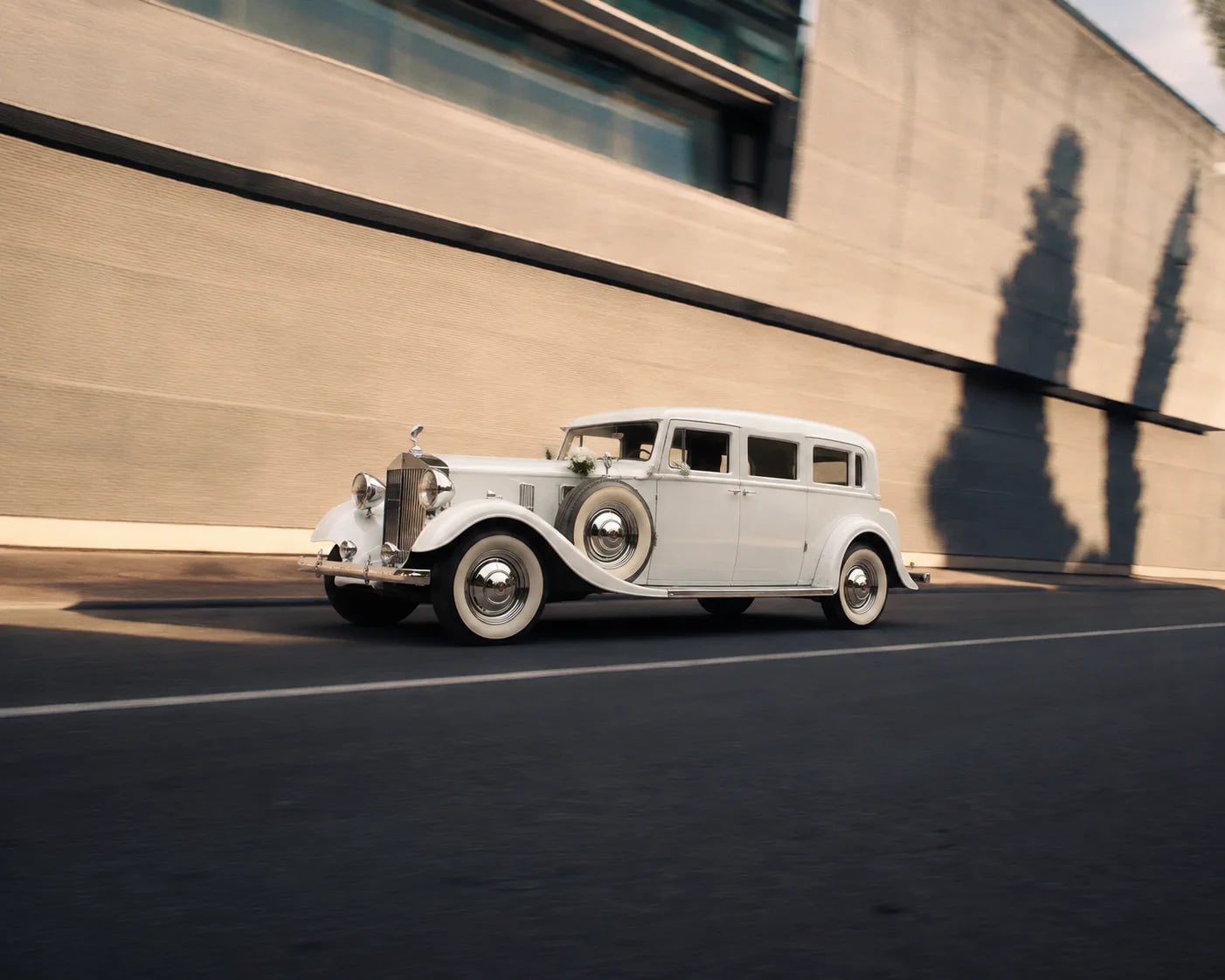 A white Rolls-Royce Prinzing wedding car facing right.