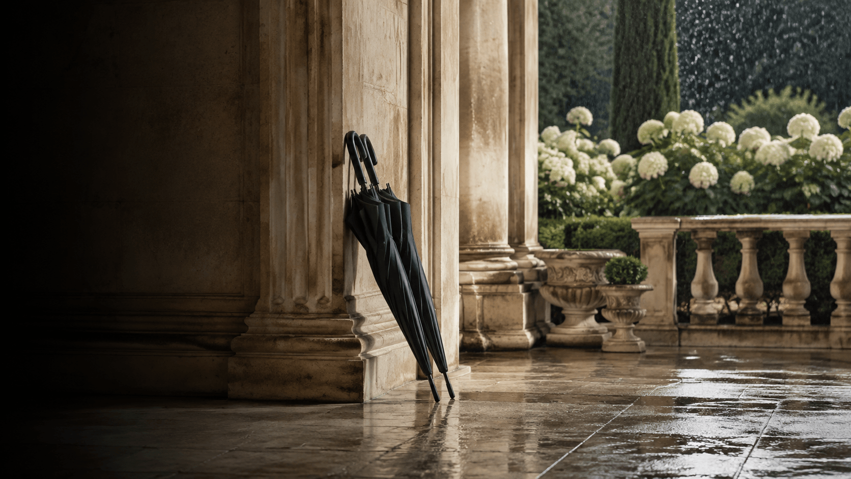 Umbrellas beside a sheltered stone entrance in the rain, editorial image